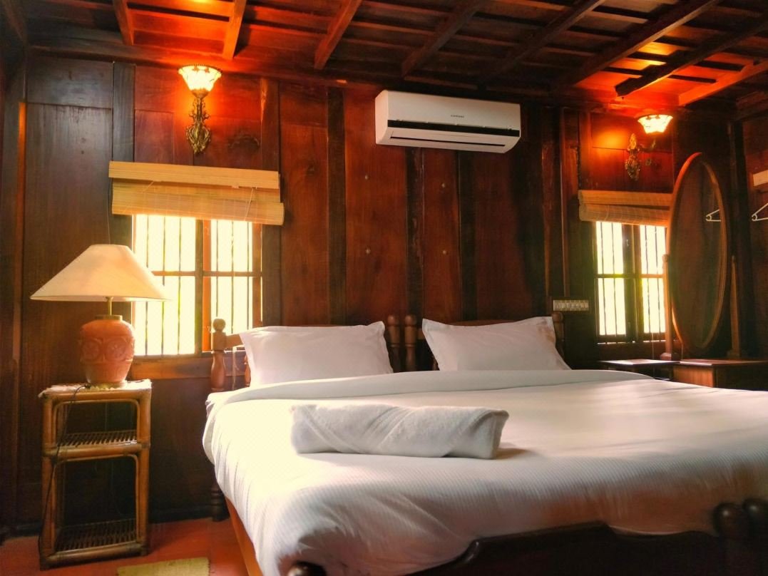 Wood-panelled bedroom with four-poster bed